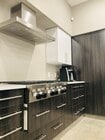 Full kitchen with gas range and hood fan